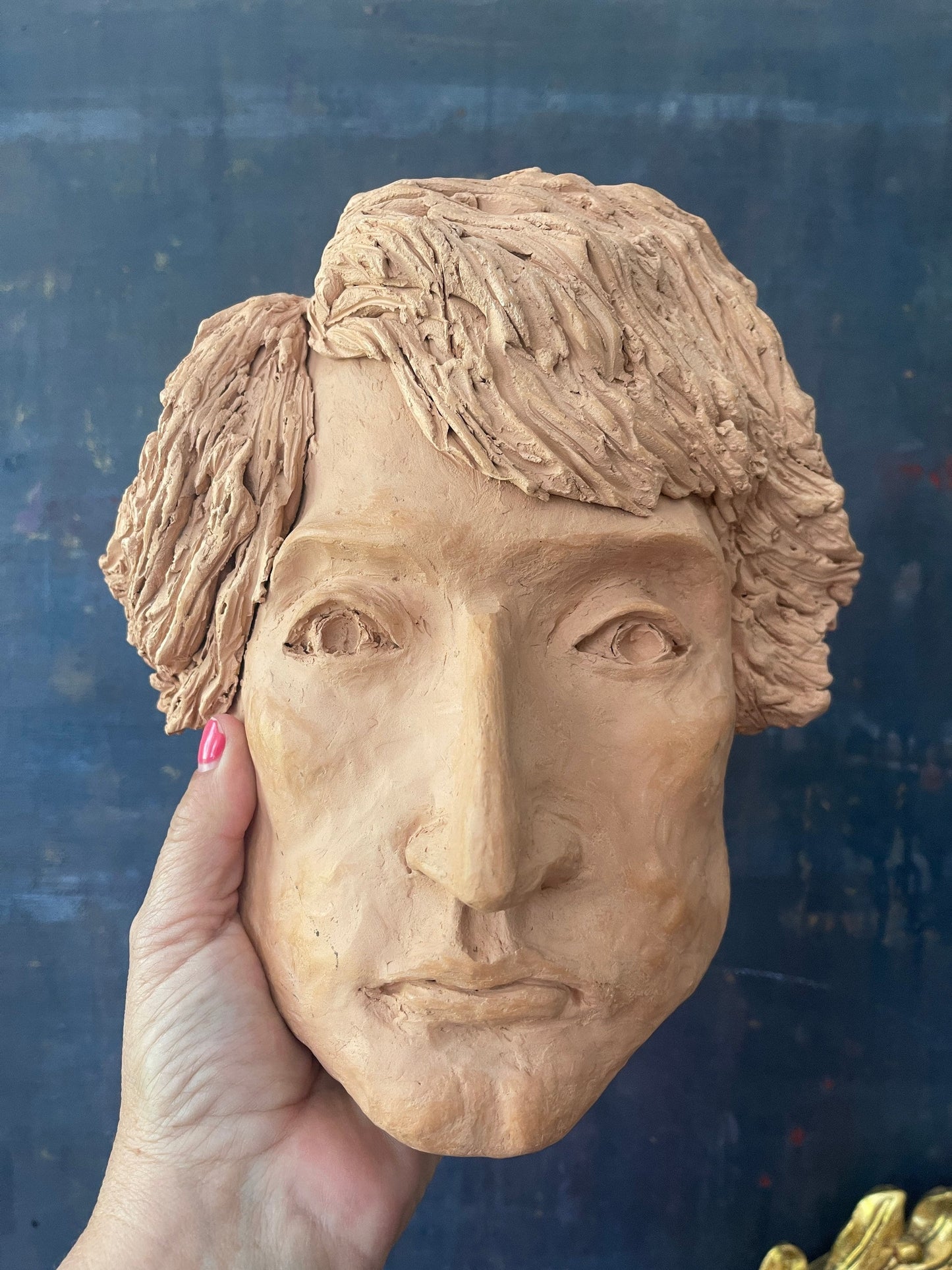 Clay sculpture of face postmodern decor