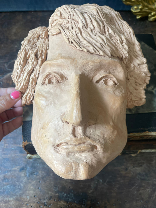 Clay sculpture of face postmodern decor